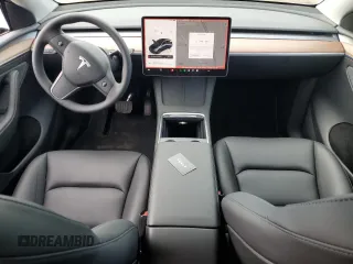 2025 Tesla Model Y Long Range with VIN 7SAYGDED7SF320702, listed as a Copart auction lot 54655325 with 1,169 mi miles and Salvage Title. Bid and sale history available at DreamBid. Image 8.