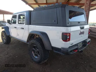 2022 Jeep Gladiator Rubicon with VIN 1C6JJTBM6NL145009, listed as a IAAI auction lot 42134143 with 59,438 mi miles and . Bid and sale history available at DreamBid. Image 3.