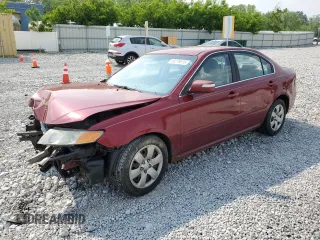 2009 Kia Optima LX z VIN KNAGE228795334599, wystawiony jako Copart lot #59276515 z przebiegiem 180 399 mil mil oraz Szkoda całkowita • Salvage title. Historia ofert i sprzedaży dostępna na DreamBid. Obrazek 1.