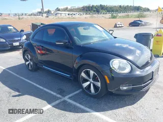2012 Volkswagen Beetle 2.0T Turbo w/Sun/Snd/Nav PZEV with VIN 3VWVA7AT1CM654881, listed as a IAAI auction lot 41927926 with 71,357 mi miles. Bid and sale history available at carsss.com. Image 1.