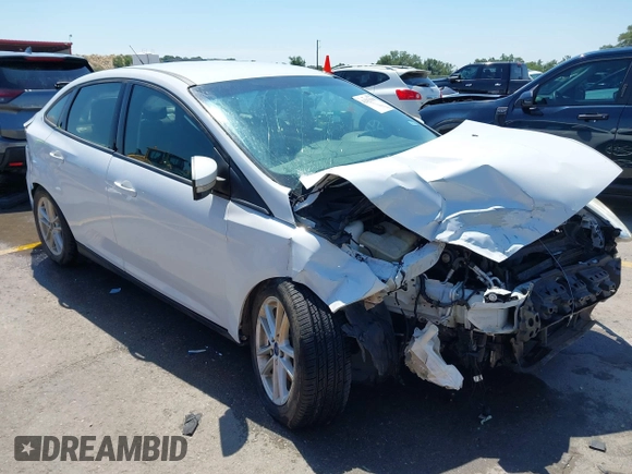 2016 Ford Focus SE z VIN 1FADP3F23GL338496, wystawiony jako IAAI lot #42333608 z przebiegiem 76 972 mil mil oraz . Historia ofert i sprzedaży dostępna na DreamBid. Obrazek 1.