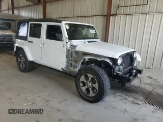 2016 Jeep Wrangler Unlimited Sahara with VIN 1C4BJWEGXGL310499, listed as a Copart auction lot 59756015 with 128,498 mi miles and Salvage title. Bid and sale history available at DreamBid. Image 4.