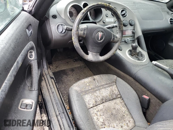 2006 Pontiac Solstice z VIN 1G2MB33B56Y000343, wystawiony jako Copart lot #74567004 z przebiegiem Nie podano mil oraz Szkoda całkowita • Salvage title. Historia ofert i sprzedaży dostępna na DreamBid. Obrazek 8.