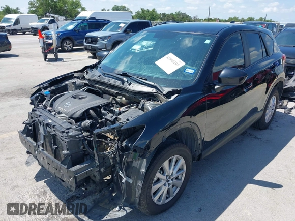 2014 Mazda CX-5 Sport with VIN JM3KE2BE9E0402015, listed as a IAAI auction lot 42098197 with 65,328 mi miles and . Bid and sale history available at carsss.com. Image 2.
