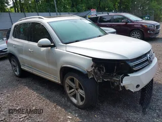 2014 Volkswagen Tiguan SEL with VIN WVGAV3AX7EW022239, listed as a IAAI auction lot 42381670 with 180,729 mi miles and . Bid and sale history available at DreamBid. Image 1.