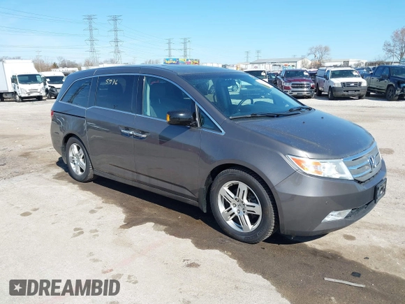 2012 Honda Odyssey Touring with VIN 5FNRL5H9XCB077351, listed as a IAAI auction lot 42045976 with 146,290 mi miles and . Bid and sale history available at DreamBid. Image 1.