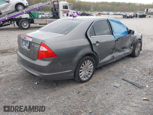 2010 Ford Fusion Hybrid z VIN 3FADP0L31AR326917, wystawiony jako IAAI lot #41938486 z przebiegiem 132 845 mil mil oraz . Historia ofert i sprzedaży dostępna na DreamBid. Obrazek 4.