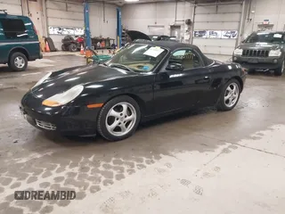 1999 Porsche Boxster z VIN WP0CA2984XU622814, wystawiony jako IAAI lot #42234977 z przebiegiem 52 404 mil mil oraz . Historia ofert i sprzedaży dostępna na DreamBid. Obrazek 2.