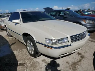 2000 Cadillac Eldorado z VIN 1G6EL12Y0YB704658, wystawiony jako Copart lot #77596814 z przebiegiem Nie podano mil oraz Nie do naprawy • Non repairable. Historia ofert i sprzedaży dostępna na DreamBid. Obrazek 4.