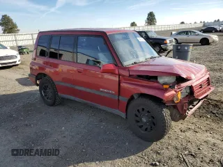 1995 Suzuki Sidekick z VIN JS3TD03V6S4113425, wystawiony jako Copart lot #76973244 z przebiegiem 152 638 mil mil oraz Szkody całkowita. Historia ofert i sprzedaży dostępna na DreamBid. Obrazek 4.