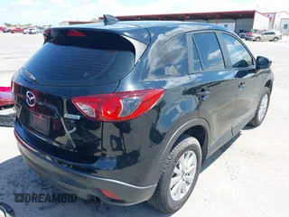 2014 Mazda CX-5 Sport with VIN JM3KE2BE9E0402015, listed as a IAAI auction lot 42098197 with 65,328 mi miles and . Bid and sale history available at carsss.com. Image 4.
