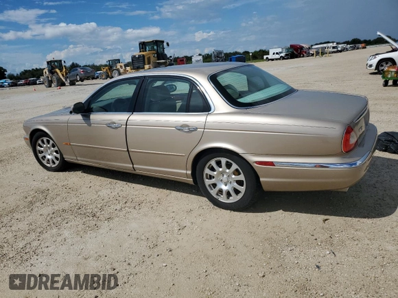 2004 Jaguar XJ with VIN SAJWA71C24SG28164, listed as a Copart auction lot 73968134 with 0 mi miles and Salvage Title. Bid and sale history available at carsss.com. Image 2.