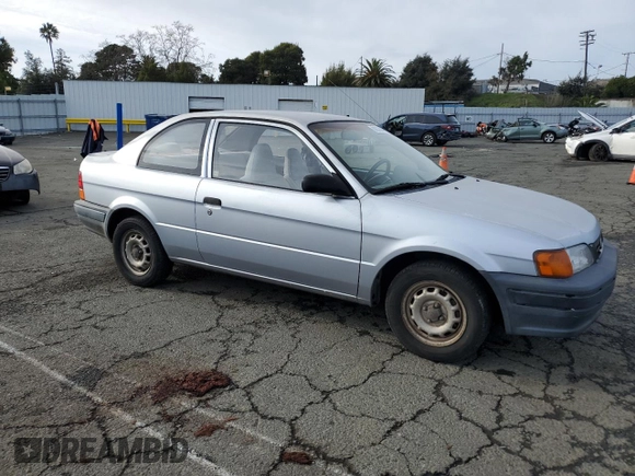 1996 Toyota Tercel DX z VIN JT2AC52L2T0137695, wystawiony jako Copart lot #86535844 z przebiegiem 246 554 mil mil oraz Czysty tytuł • Clean title. Historia ofert i sprzedaży dostępna na DreamBid. Obrazek 4.
