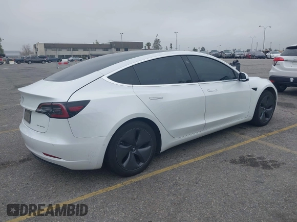 2020 Tesla Model 3 Long Range with VIN 5YJ3E1EB0LF803217, listed as a IAAI auction lot 41871940 with 130,391 mi miles. Bid and sale history available at carsss.com. Image 4.