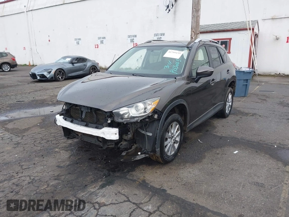 2016 Mazda CX-5 Touring with VIN JM3KE4CY5G0695242, listed as a IAAI auction lot 41795135 with 195,162 mi miles. Bid and sale history available at carsss.com. Image 16.