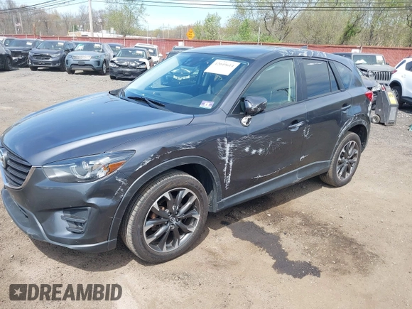 2016 Mazda CX-5 Grand Touring z VIN JM3KE4DY1G0893119, wystawiony jako IAAI lot #42049614 z przebiegiem 102 506 mil mil oraz . Historia ofert i sprzedaży dostępna na DreamBid. Obrazek 6.