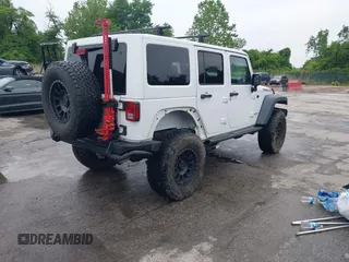 2014 Jeep Wrangler Unlimited Rubicon with VIN 1C4HJWFG4EL104827, listed as a IAAI auction lot 42236622 with 90,935 mi miles and . Bid and sale history available at DreamBid. Image 4.