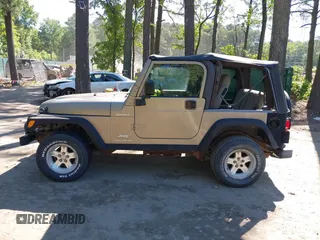 2003 Jeep Wrangler Sport z VIN 1J4FA49S13P313180, wystawiony jako IAAI lot #42349673 z przebiegiem 141 073 mil mil oraz . Historia ofert i sprzedaży dostępna na DreamBid. Obrazek 14.