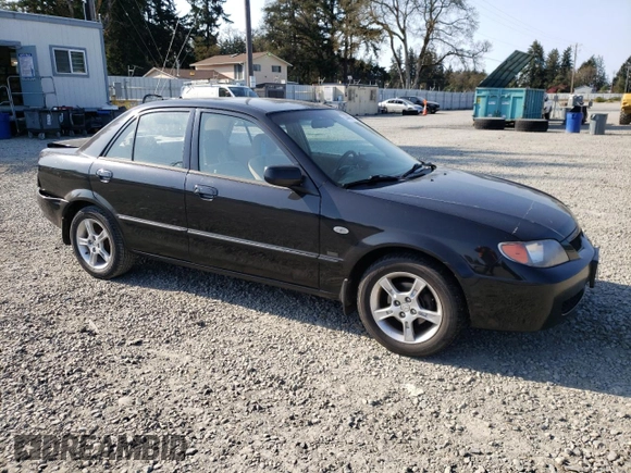 2003 Mazda Protege DX with VIN JM1BJ226231214537, listed as a Copart auction lot 54448615 with 147,753 mi miles and Salvage Title. Bid and sale history available at DreamBid. Image 4.