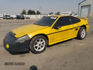 1986 Pontiac Fiero z VIN 1G2PG9796GP256622, wystawiony jako Copart lot #69203894 z przebiegiem 38 964 mil mil oraz Szkody całkowita. Historia ofert i sprzedaży dostępna na DreamBid. Obrazek 1.