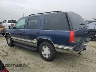 1999 GMC Yukon with VIN 1GKEK13R2XJ739931, listed as a Copart auction lot 74583734 with 115,605 mi miles and Salvage Title. Bid and sale history available at carsss.com. Image 2.