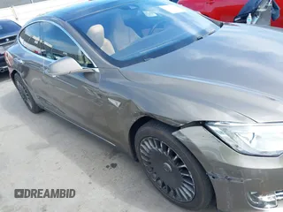 2015 Tesla Model S 85 with VIN 5YJSA1E14FF120455, listed as a IAAI auction lot 42053306 with 62,817 mi miles and . Bid and sale history available at DreamBid. Image 6.
