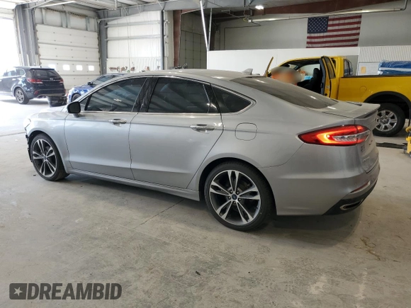 2020 Ford Fusion Titanium с VIN 3FA6P0K90LR112034, выставлен на аукционе Copart как лот 56740025 с пробегом 89 117 миль миль и Списание • Salvage title. История ставок и продаж доступна на DreamBid. Изображение 2.