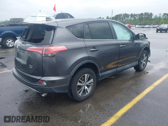 2018 Toyota RAV4 XLE with VIN 2T3RFREV5JW701564, listed as a IAAI auction lot 41976067 with 128,404 mi miles. Bid and sale history available at carsss.com. Image 4.
