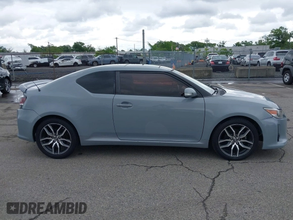 2014 Scion tC z VIN JTKJF5C71E3081033, wystawiony jako IAAI lot #42333111 z przebiegiem 144 124 mil mil oraz . Historia ofert i sprzedaży dostępna na DreamBid. Obrazek 13.