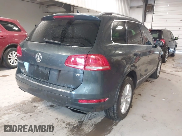 2013 Volkswagen Touareg Lux with VIN WVGEF9BP6DD007032, listed as a IAAI auction lot 41684721 with 147,249 mi miles and . Bid and sale history available at DreamBid. Image 4.