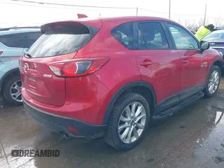 2015 Mazda CX-5 Grand Touring with VIN JM3KE4DY7F0477770, listed as a IAAI auction lot 41617849 with 106,135 mi miles. Bid and sale history available at carsss.com. Image 4.