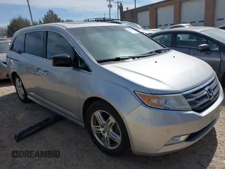 2012 Honda Odyssey Touring with VIN 5FNRL5H92CB108690, listed as a IAAI auction lot 41826580 with 150,327 mi miles and . Bid and sale history available at DreamBid. Image 1.