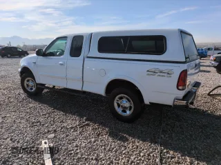 1999 Ford F-150 XL with VIN 1FTRX18L2XKA97143, listed as a Copart auction lot 52973695 with 115,180 mi miles and Salvage Title. Bid and sale history available at carsss.com. Image 2.