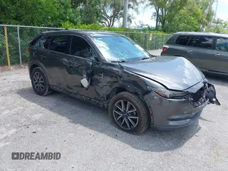 2018 Mazda CX-5 Grand Touring z VIN JM3KFADM7J0314781, wystawiony jako IAAI lot #42687565 z przebiegiem 154 593 mil mil oraz . Historia ofert i sprzedaży dostępna na DreamBid. Obrazek 1.