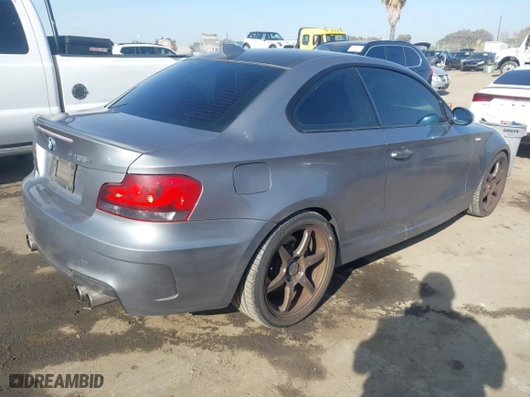 2009 BMW 1 Series 135i with VIN WBAUC73549VK80091, listed as a IAAI auction lot 41228611 with 128,515 mi miles. Bid and sale history available at carsss.com. Image 4.