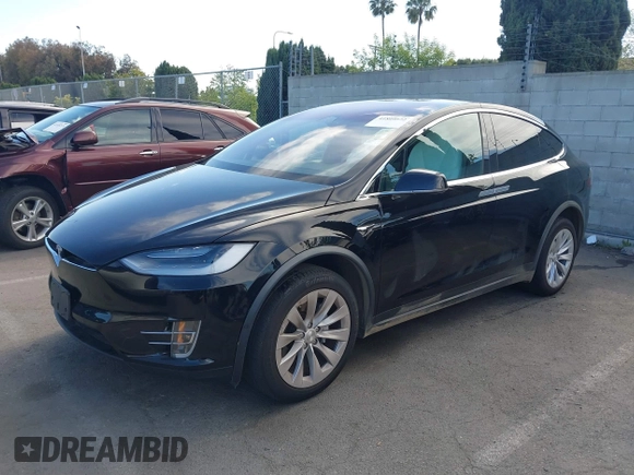 2020 Tesla Model X Long Range with VIN 5YJXCDE20LF265157, listed as a IAAI auction lot 41809572 with 58,599 mi miles. Bid and sale history available at carsss.com. Image 2.