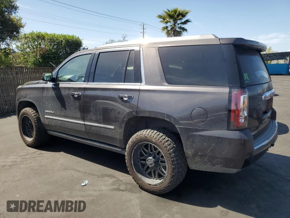 2015 GMC Yukon Denali with VIN 1GKS2CKJ8FR596848, listed as a Copart auction lot 52048105 with 129,935 mi miles and Salvage Title. Bid and sale history available at carsss.com. Image 2.