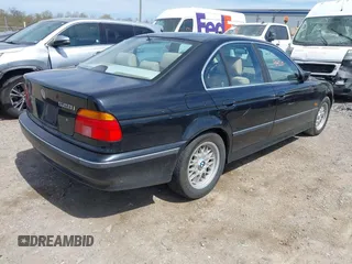 1999 BMW 5 Series 528iA with VIN WBADM6331XBY29010, listed as a IAAI auction lot 42103420 with 196,575 mi miles. Bid and sale history available at carsss.com. Image 4.