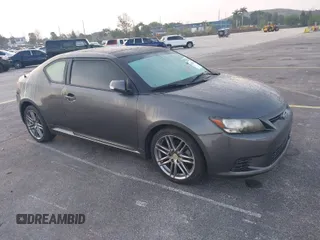 2012 Scion tC with VIN JTKJF5C74C3026945, listed as a IAAI auction lot 41757437 with 104,039 mi miles. Bid and sale history available at carsss.com. Image 1.
