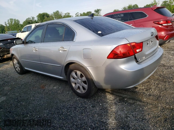 2009 Kia Optima LX z VIN KNAGE228195332931, wystawiony jako Copart lot #55279665 z przebiegiem 295 523 mil mil oraz Szkoda całkowita • Salvage title. Historia ofert i sprzedaży dostępna na DreamBid. Obrazek 2.