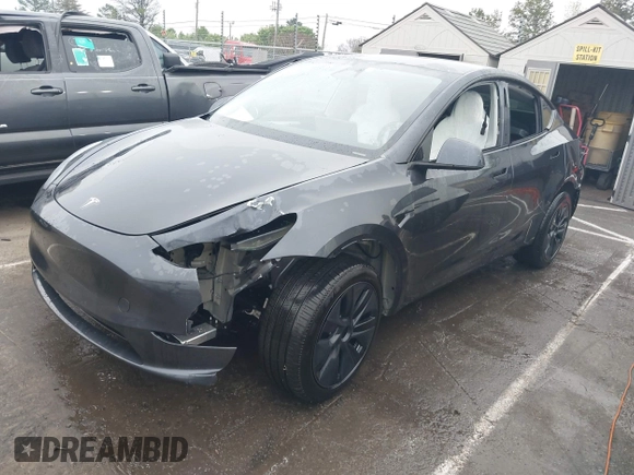 2025 Tesla Model Y Long Range with VIN 7SAYGDED8SA340082, listed as a IAAI auction lot 41915369 with 7,296 mi miles and . Bid and sale history available at DreamBid. Image 2.