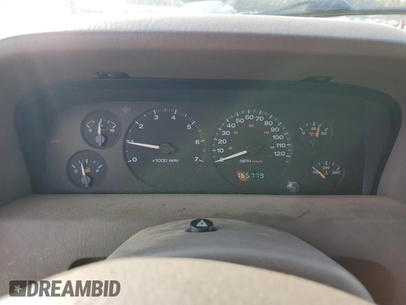 1999 Jeep Grand Cherokee Limited with VIN 1J4G268S7XC668348, listed as a Copart auction lot 77824084 with 165,779 mi miles and Salvage title. Bid and sale history available at DreamBid. Image 9.