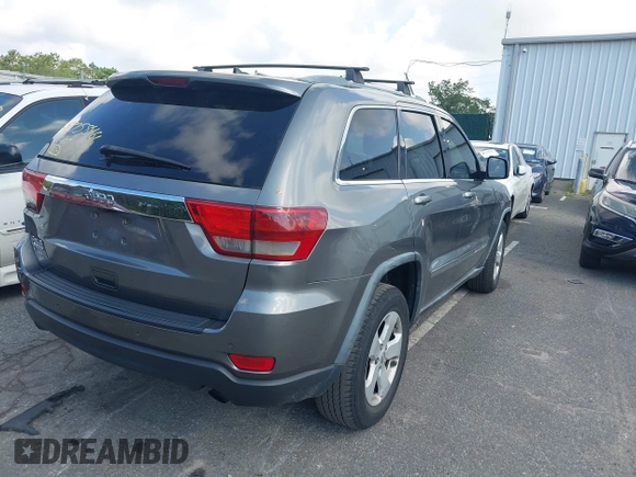 2011 Jeep Grand Cherokee Laredo with VIN 1J4RR4GG7BC736694, listed as a IAAI auction lot 42758461 with 159,875 mi miles and . Bid and sale history available at DreamBid. Image 4.