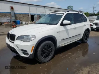 2012 BMW X5 35i with VIN 5UXZV4C54CL763857, listed as a Copart auction lot 57943195 with 143,522 mi miles and Salvage title. Bid and sale history available at DreamBid. Image 1.