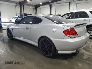 2006 Hyundai Tiburon GT z VIN KMHHN65F96U203924, wystawiony jako Copart lot #43624185 z przebiegiem 120 403 mil mil oraz Szkoda całkowita • Salvage title. Historia ofert i sprzedaży dostępna na DreamBid. Obrazek 2.