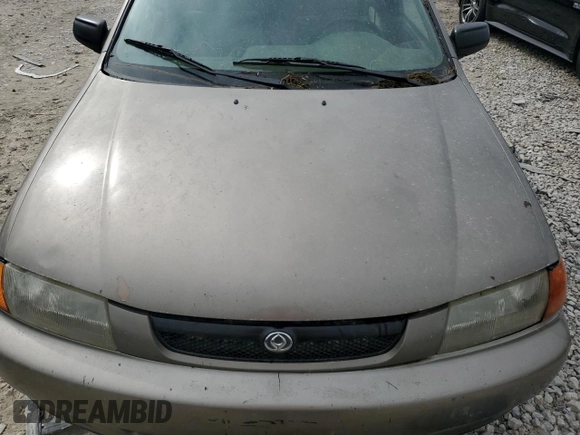 1997 Mazda Protege DX z VIN JM1BC1414V0103244, wystawiony jako Copart lot #56219745 z przebiegiem Nie podano mil oraz Szkoda całkowita • Salvage title. Historia ofert i sprzedaży dostępna na DreamBid. Obrazek 11.