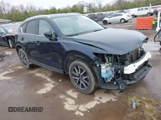 2018 Mazda CX-5 Grand Touring z VIN JM3KFADMXJ0407553, wystawiony jako IAAI lot #41915631 z przebiegiem 113 090 mil mil oraz . Historia ofert i sprzedaży dostępna na DreamBid. Obrazek 1.