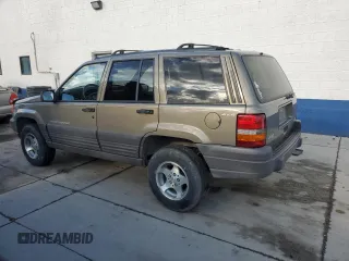 1996 Jeep Grand Cherokee Laredo with VIN 1J4GZ58S3TC245928, listed as a Copart auction lot 57313735 with 165,733 mi miles and Salvage title. Bid and sale history available at DreamBid. Image 2.