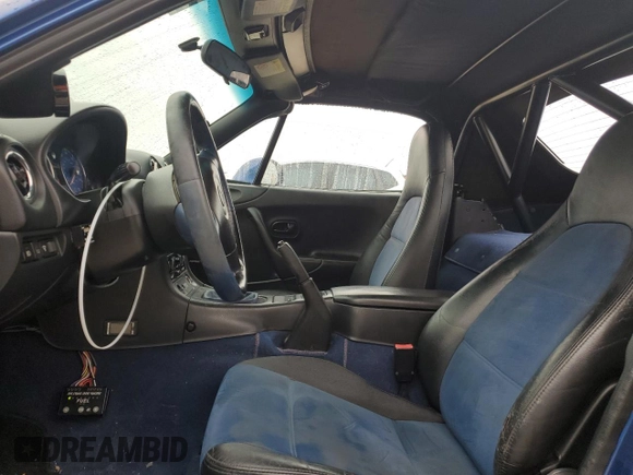 1999 Mazda MX-5 Miata with VIN JM1NB3532X0134801, listed as a Copart auction lot 83838374 with 97,015 mi miles and Salvage title. Bid and sale history available at DreamBid. Image 7.