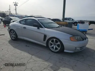 2003 Hyundai Tiburon GT z VIN KMHHN65F13U102985, wystawiony jako Copart lot #45294325 z przebiegiem 326 919 mil mil oraz Szkoda całkowita • Salvage title. Historia ofert i sprzedaży dostępna na DreamBid. Obrazek 4.